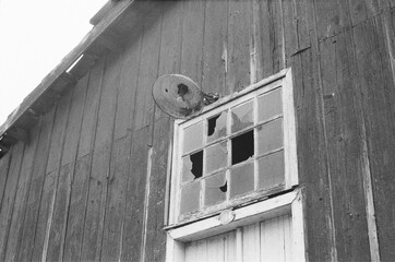Broken window on old wooden house