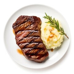 Beautiful fresh juicy steak with mashed potatoes on a plate on a white background