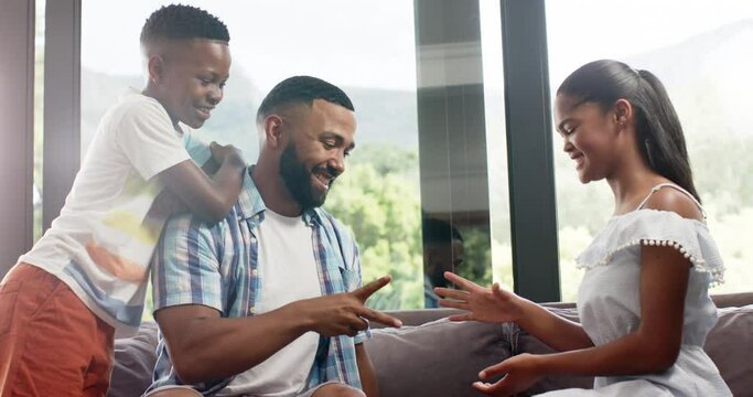 Happy african american son and father playing rock, paper, scissors with daughter, slow motion