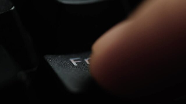 Keyboard button FN. Macro shot of finger pressing FN button