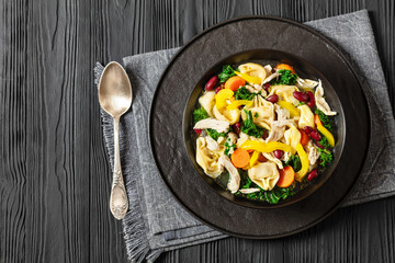 chicken minestrone soup with tortelloni in bowl