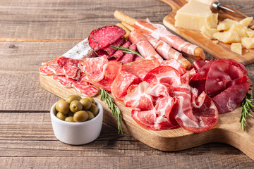 Charcuterie board. Antipasti appetizers of meat platter with salami, prosciutto crudo or jamon and olives.
