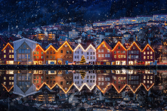 Winter dusk view of the famous Bryggen district at Bergen, Norway, decorated for Christmas with snow