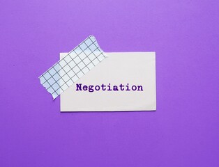 Stick note on purple background with text written NEGOTIATION  - strategic discussion of two or...