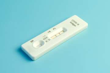 Home Antigen Test Kit virus covid-19 negative and positive, blue background,