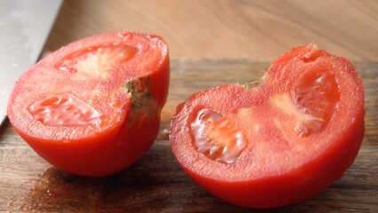 Peeled Fresh Tomato Halves on Wooden Surface. Close-up, shallow dof.