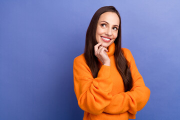 Portrait of beautiful lady wear orange jumper in brown hair touch chin looking curious novelty admiring isolated on purple color background