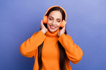 Portrait of young lady closed eyes touching headphones listen high quality soundtrack melody jazz isolated on purple color background