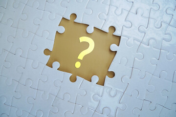 Question mark on jigsaw puzzle on blank background. Concept of question, faq, q&a, confusion and...