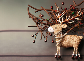 Craft work of a reindeer with Christmas decorations, space for text, Christmas card