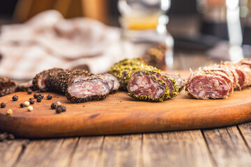 Smoked dried sausage. Sliced sausage on cutting board.