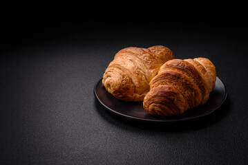 Delicious crispy baked sweet croissants with filling on a ceramic plate