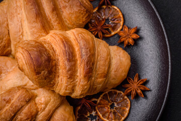 Delicious crispy baked sweet croissants with filling on a ceramic plate