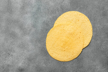 Corn tortilla on a gray concrete background,. Top view, flat lay, copy space.