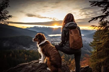 Poster Im Rahmen  charming traveler girl and her border collie dog are enjoying the sunset in the mountains. Traveling alone © olga