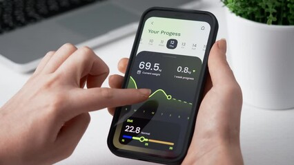 Tracking weight loss progress. Monitoring weight loss using fitness app for mobile phone.