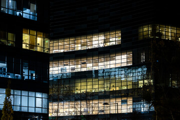 Night windows of an office building, an office without people. Night city landscape
