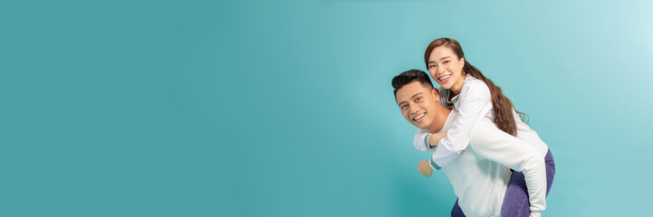 Young beautiful couple isolated on light blue background