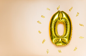 A balloon made of gold foil with the number zero. A birthday or anniversary card with the...