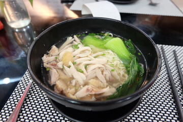 chicken and vegetable soup noodles in bowl