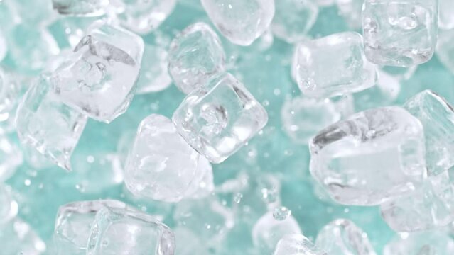 Super slow motion of rotating ice cubes, top view shot. Filmed on high speed cinema camera, 1000 fps, placed on high speed cine bot, following the object. Speed ramp effect.