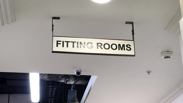Fitting rooms sign in the shop with videcam ,hanging in clothing store .concept fitting shopping private life