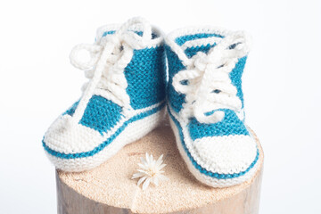 winter baby knitted woolen shoes isolated on white background