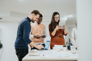 Diverse professionals collaborate in a creative office, analyzing reports, discussing strategies,...