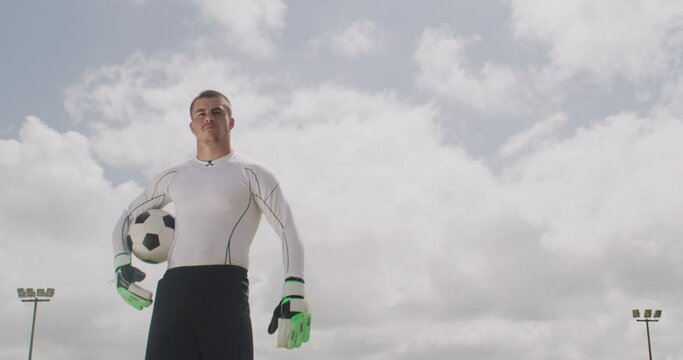 Soccer, ball and portrait of goalkeeper on field for game, practice match and competition outdoors. Sports mockup, serious man and portrait of player with football for training, fitness and exercise