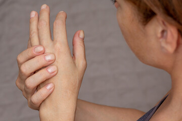 Woman hands showing numb hand over cropped body - obrazy, fototapety, plakaty