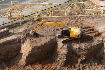 Yellow excavator doing earthwork