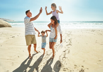 Parents, children and beach for high five in summer for travel vacation, ocean sunshine or sibling...