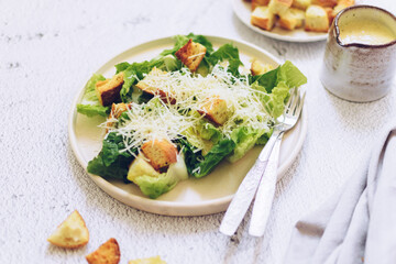 Classic caesar salad with lettuce, croutons and parmesan cheese