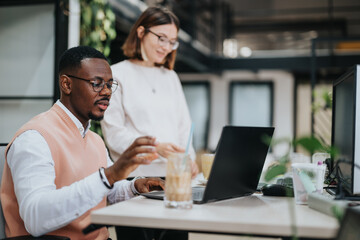 Successful Teamwork in a Corporate Office Between Two Young Multiethnic Coworkers.