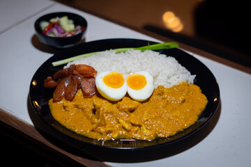 Tasty dinner with  Pork Spice Curry rice in bowl on wooden background top view chinese food