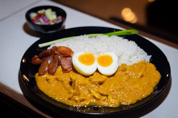 Tasty dinner with  Pork Spice Curry rice in bowl on wooden background top view chinese food