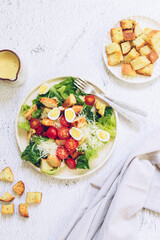 Classic caesar salad with grilled chicken, lettuce, croutons and parmesan cheese