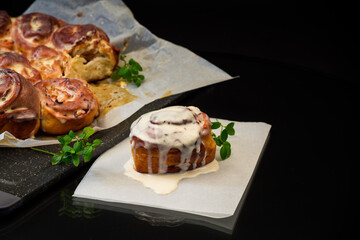 cooked baked sweet Cinnabon with cream in baking paper .