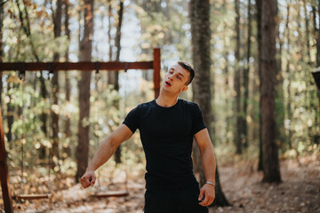 A happy hiker explores a forest landscape, enjoying an active weekend in nature. He exercises outdoors, embracing an adventurous and healthy lifestyle in the mountains.