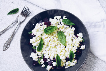 Healthy salad with beet root, cottage cheese and basil