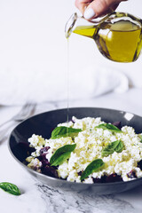 Healthy salad with beet root, cottage cheese and basil