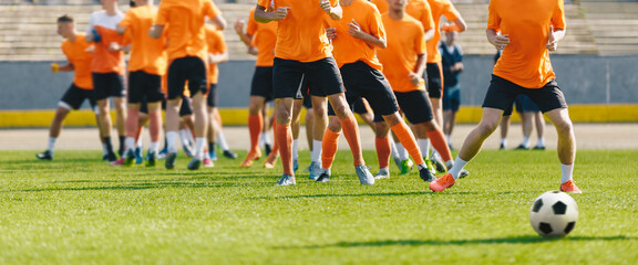 Soccer Players on Daily Practice Unit. Football Club Training Session. Athletes Running on Soccer Grass Field. Soccer Team Training Together Before League Competition Match