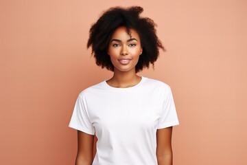 design mockup with black woman wearing plain blank white t-shirt on a pastel peach background, studio portrait