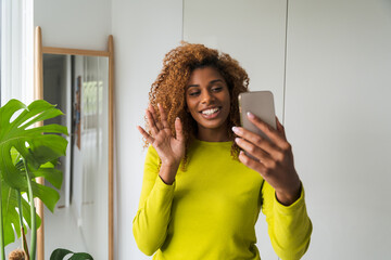 African american happy woman video calling mobile phone