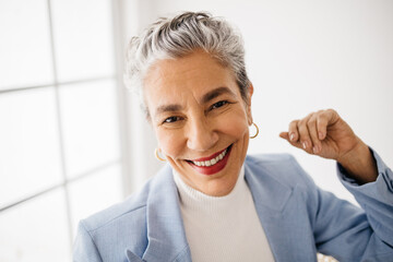 Senior business woman smiling in her office, confident in herself as a top business professional