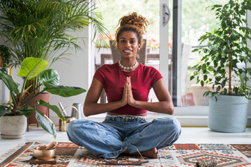 Full length view of the brunette woman meditating with hands in prayer gesture