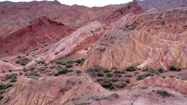 aerial view, drone shot, red sandstone formation, iron-rich minerals in the sand break down and the iron is oxidized, hematite crystals, compacted and cemented together over millions of years.