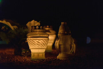 Memory lantern with burning candle in the dark.White Candles Burning in the Dark Night with lights...