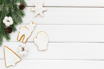White Christmas gingerbread cookies with fir tree branches. New Year background