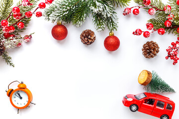 Red toy car carrying Christmas tree. Festive New Year decoration and Christmas background